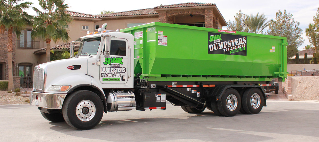 Junk Control roll-off truck at a residential cleanup